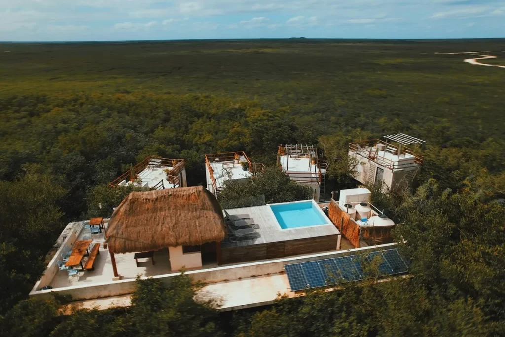 hospedagem ecológica em meio à natureza com piscina e telhado de palha